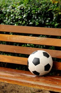 Football on benchvertical composition relax concept